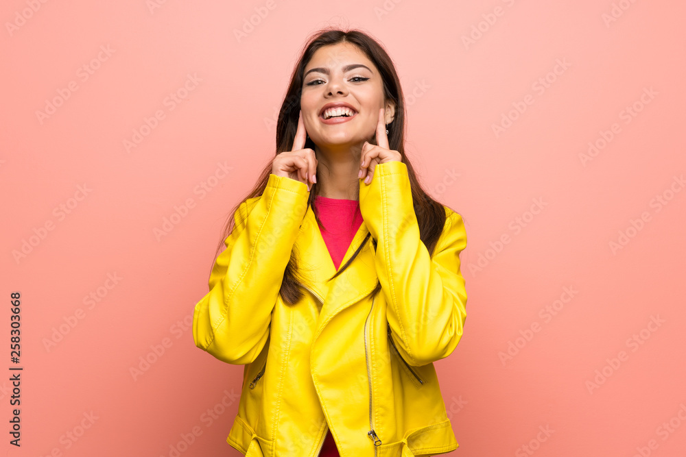 Teenager girl over pink wall smiling with a happy and pleasant expression Teenager girl over pink wall smiling with a happy and pleasant expression