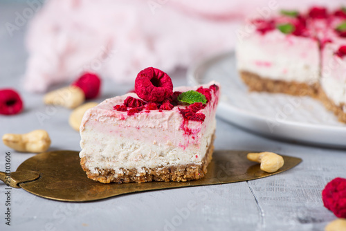 Vegan raw raspberry nut cheesecake on a light  background. Healthy vegan food concept.  Sugar, dairy and gluten free dessert