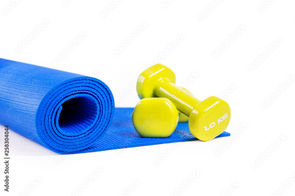 Yoga mat and dumbbells Isolated on white background Yoga mat and dumbbells Isolated on white background