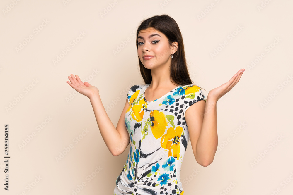 Teenager girl with floral dress making doubts gesture Teenager girl with floral dress making doubts gesture
