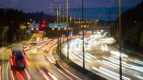 Car lights at rush hour on an motorway junction, traffic on London Orbital motorway M25, timelapse. photo