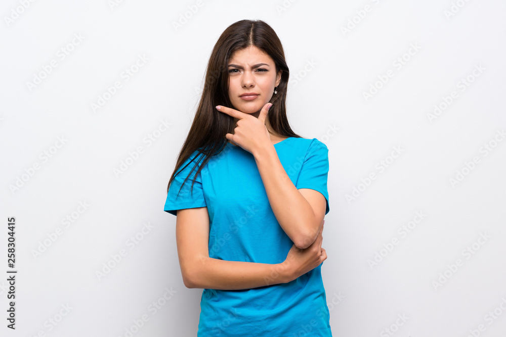 Teenager girl with blue shirt thinking Teenager girl with blue shirt thinking