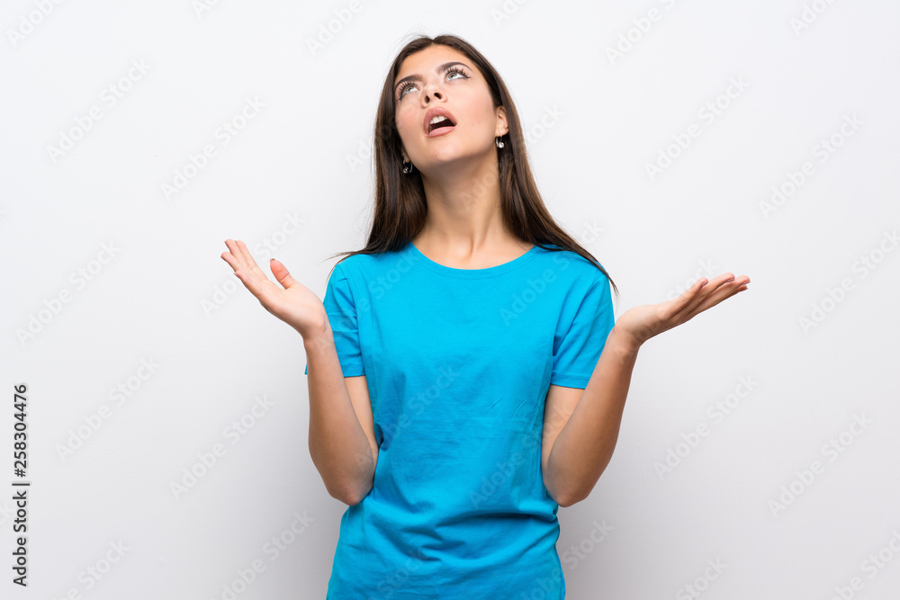 Teenager girl with blue shirt frustrated by a bad situation Teenager girl with blue shirt frustrated by a bad situation