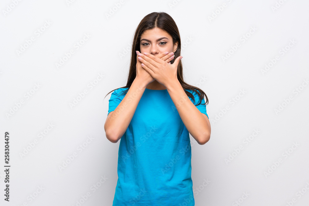 Teenager girl with blue shirt covering mouth with hands Teenager girl with blue shirt covering mouth with hands