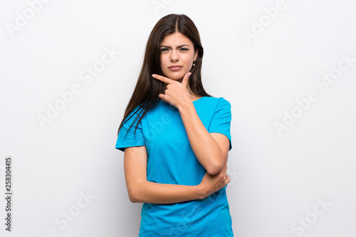 Teenager girl with blue shirt thinking © luismolinero