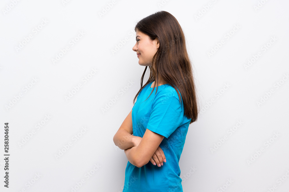 Teenager girl with blue shirt in lateral position Teenager girl with blue shirt in lateral position