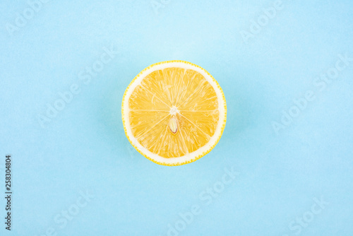 Fresh yellow lemon on a light blue background