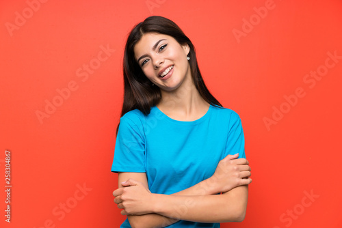 Teenager girl with blue shirt hugging