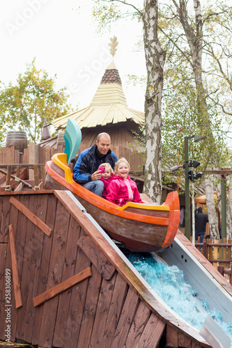 family in boot ride theme park