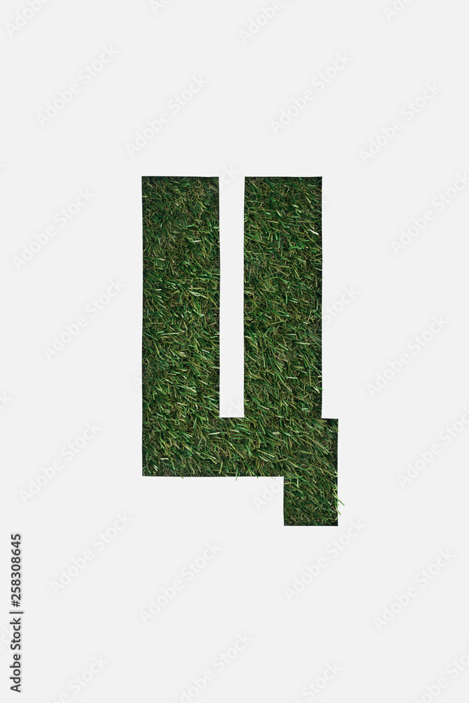 Fototapeta premium top view of cyrillic letter with green grass on background isolated on white