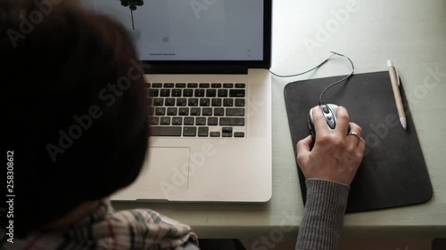 The girl is a student sitting at the table and preparing for the exam.