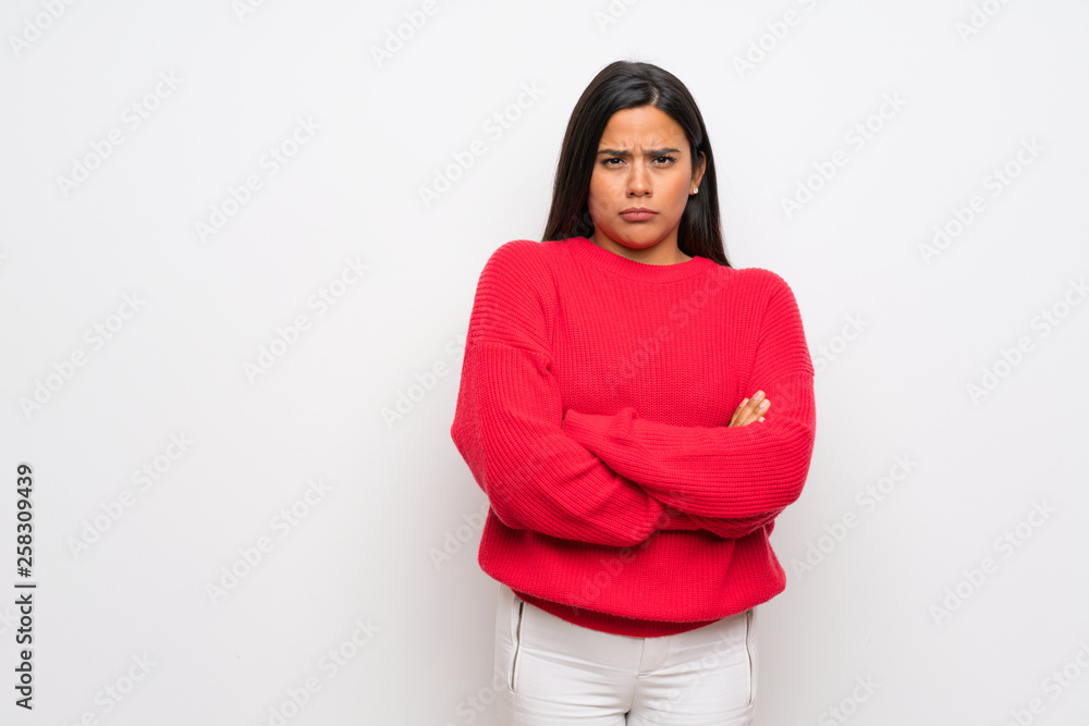 Young Colombian girl with red sweater feeling upset Young Colombian girl with red sweater feeling upset