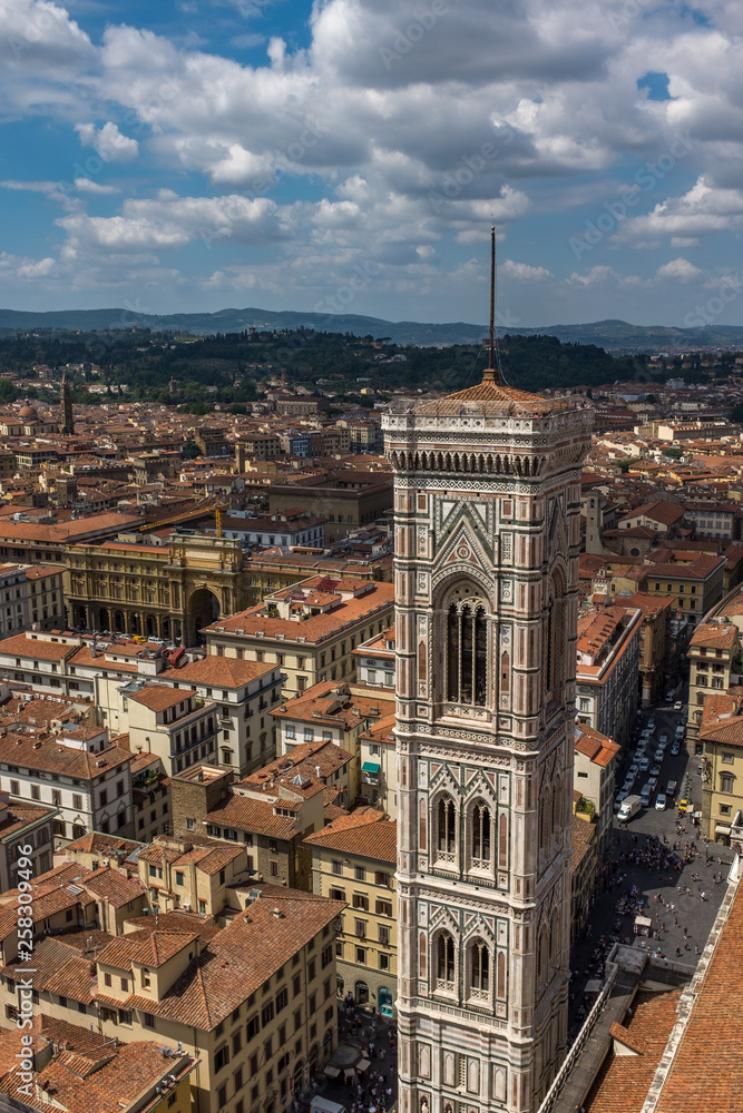 A sweeping view of the skyline and rooftops of Florence including Giotto's bell tower, from the top of the cathedral.