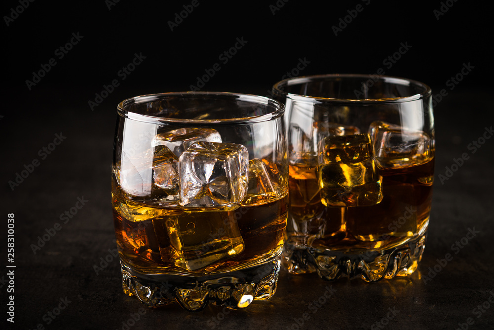 Whiskey in the glasses on black. Whiskey in the glasses on black.