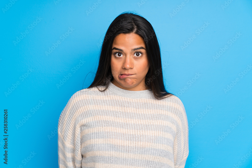 Young Colombian girl with sweater having doubts and with confuse face expression Young Colombian girl with sweater having doubts and with confuse face expression