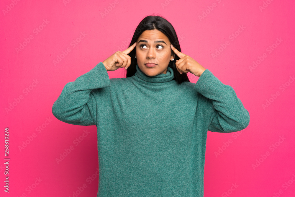 Young Colombian girl with green sweater having doubts and thinking Young Colombian girl with green sweater having doubts and thinking