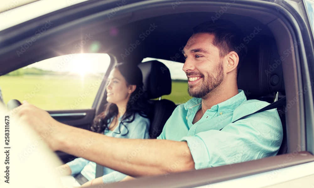 leisure, road trip, travel, family and people concept - happy man and woman driving in car leisure, road trip, travel, family and people concept - happy man and woman driving in car
