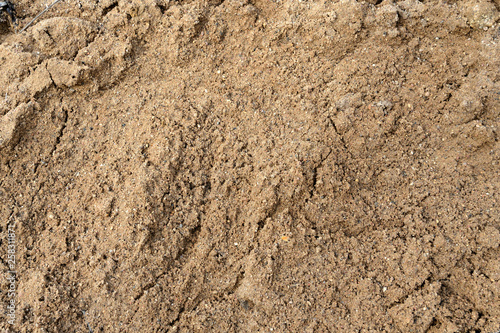 Large pile of construction sand close up as texture and background 