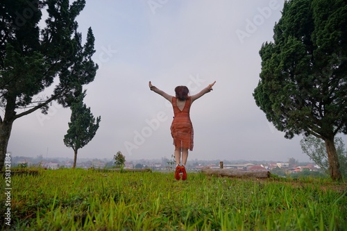 happy young woman jumping in the field