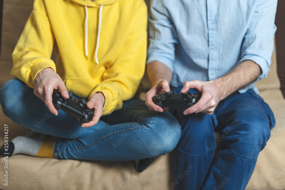 Two person playing at video games at home
