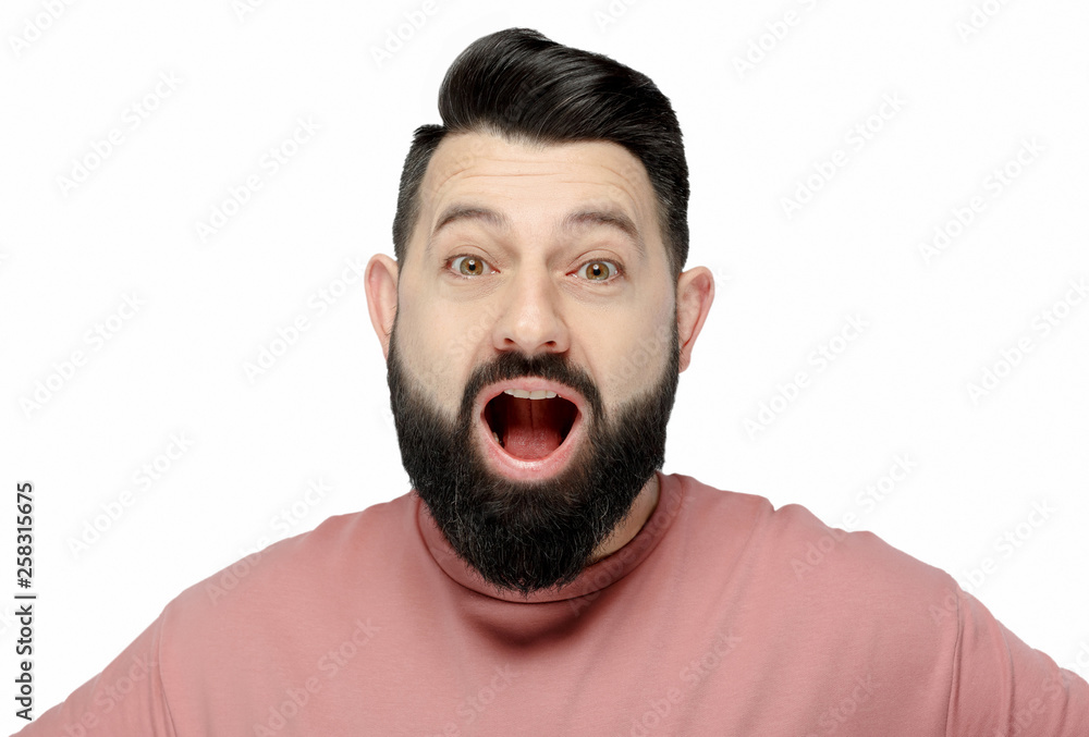 A cute young bearded man in pink shirt shows emotionally happy A cute young bearded man in pink shirt shows emotionally happy