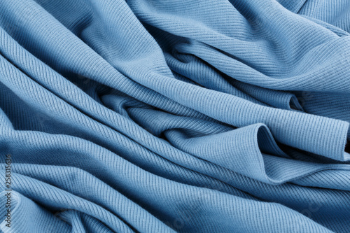 Blue cotton textile - close up of fabric texture. Cotton Fabric Texture. Top View of Cloth Textile Surface. Blue Clothing Background. Text Space. Abstract background and texture for designers.