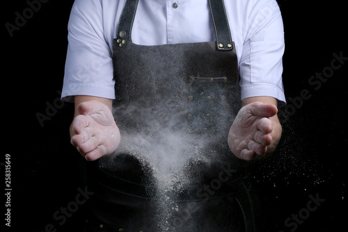 Chef hands in flour on black background. clap with flour. baking bread and and making pizza or pasta