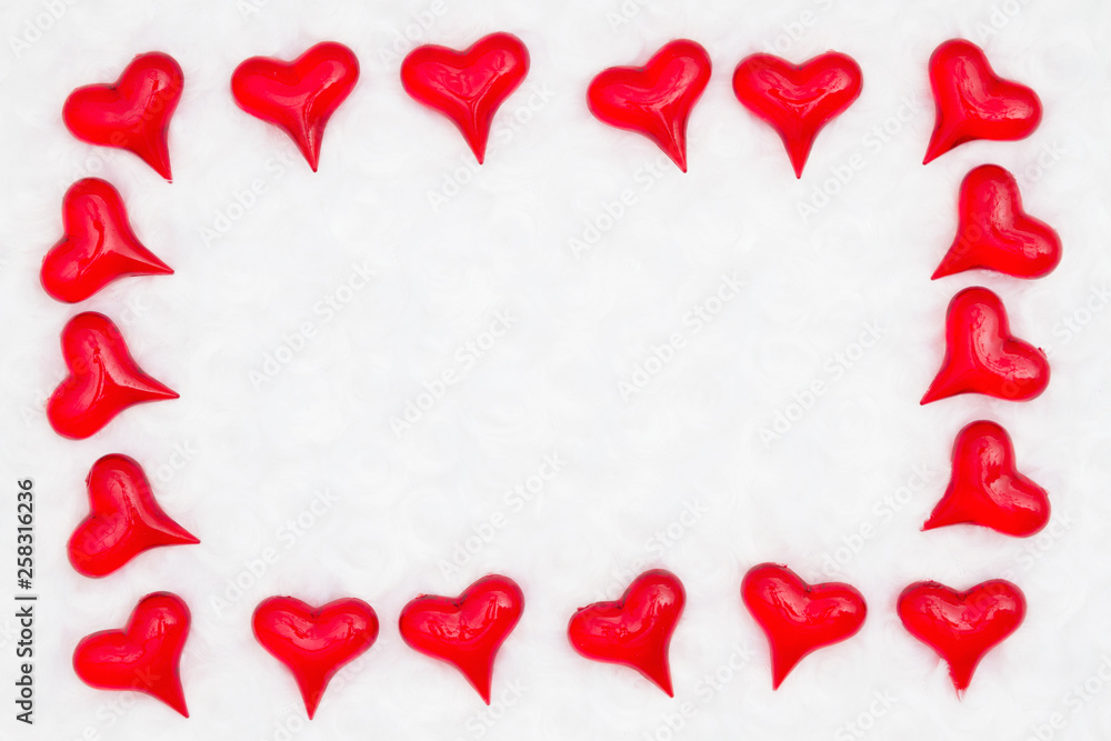 Red hearts on white fabric background