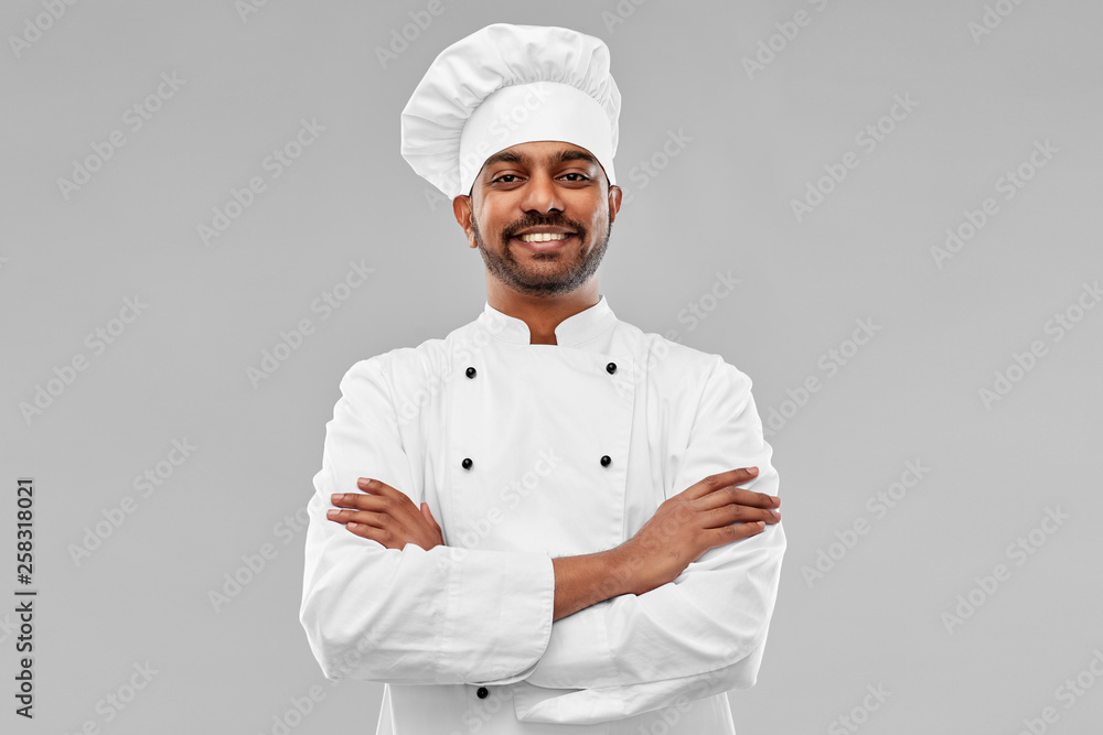 cooking, profession and people concept - happy male indian chef in toque over grey background cooking, profession and people concept - happy male indian chef in toque over grey background
