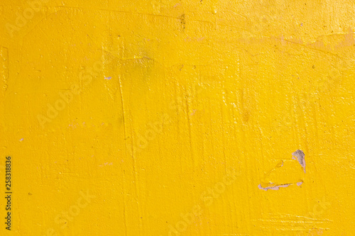Old grunge cracked vintage light yellow concrete and cement mold texture wall or floor background with weathered paint and scratches