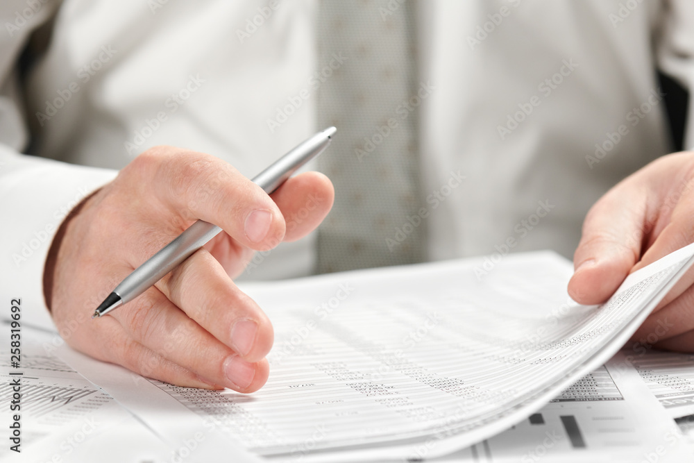 Businessman working in an office. Hands and documents closeup. Businessman working in an office. Hands and documents closeup.