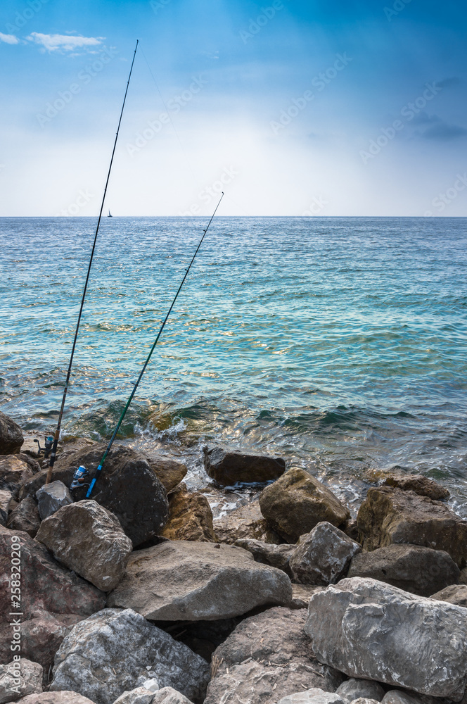Two fishing rods on the cliff