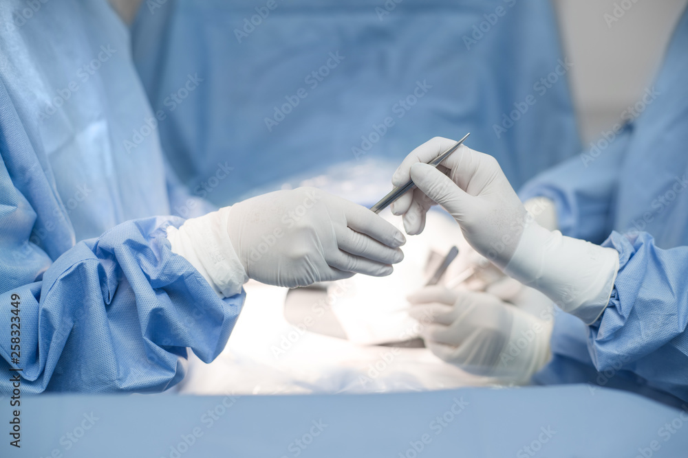 Close up of surgery team operating in operation room in hospital. send a Scalpel. Close up of surgery team operating in operation room in hospital. send a Scalpel.