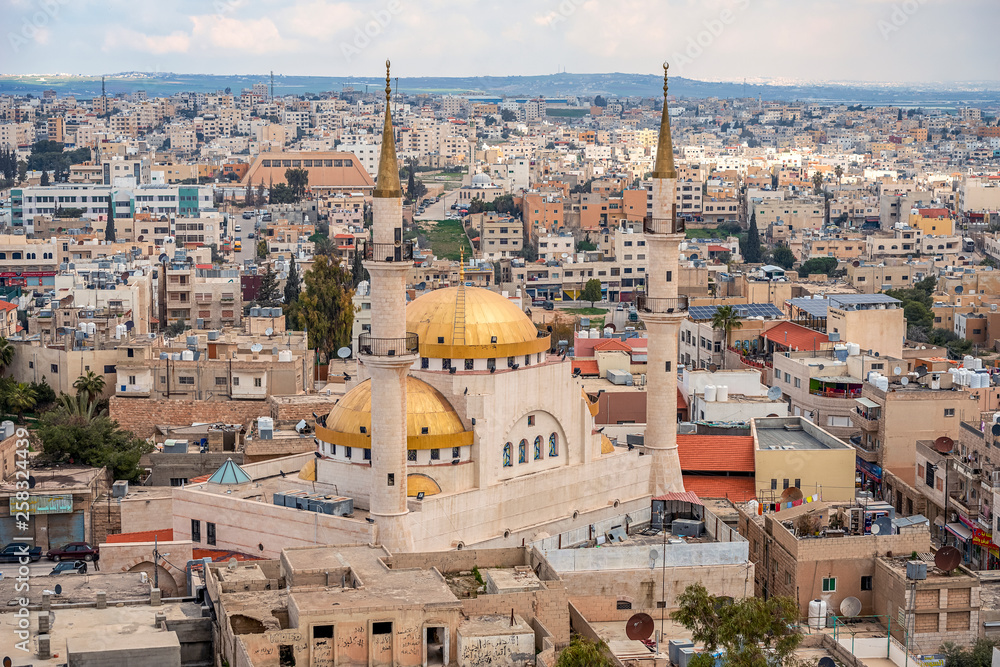 .21/22/2019 Madaba, Jordan, view of the central and largest mosque with high minarets in the ancient city of the middle east..selective focus