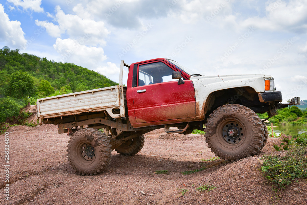 Obraz premium Car pickup truck 4X4 Offroad trekking travel in the countryside road dirt