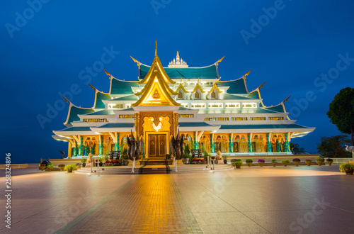 Thai temple beautiful at night twilight blue sky / Wat Pa Phu Kon Udon Thani Thailand Buddhism Temple on hill photo