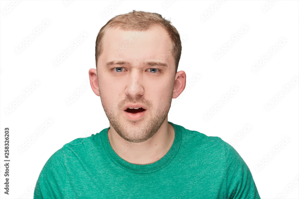 Obraz premium A funny young man in a green shirt shows disappointment