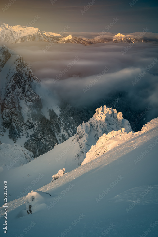 Clouds over the snow covered mountains.
