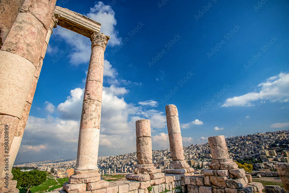 unsurpassed view of the ruins of the temple of Hercules on the top of the mountain of the Amman citadel against the background of a blue sky with clouds