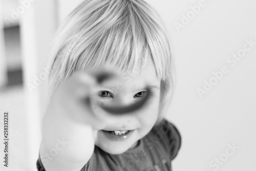 little girl looks through toilet roll