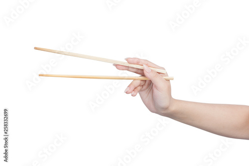 Female hand holding wooden chopsticks