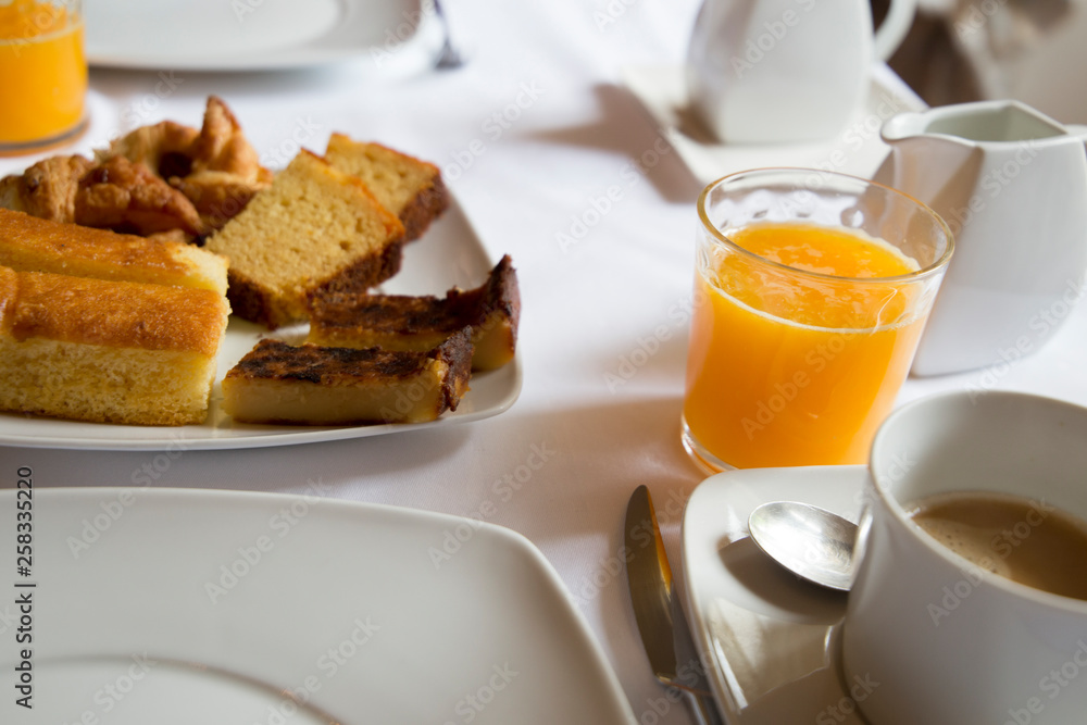 Coffee orange juice and cakes Breakfast table