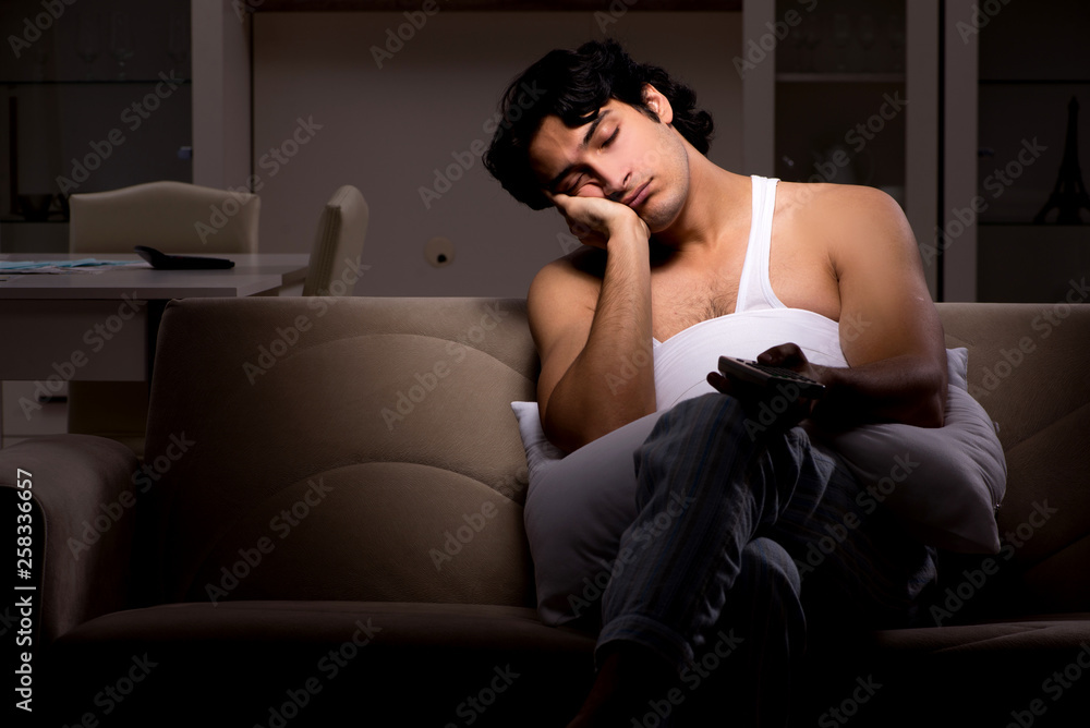 Young man suffering at home night time Young man suffering at home night time