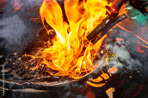 Schilderij op canvas closeup calcining hot metal steel gear parts in a factory induction furnace with