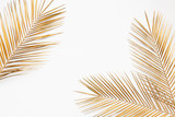 Gold painted date palm branches on white background
