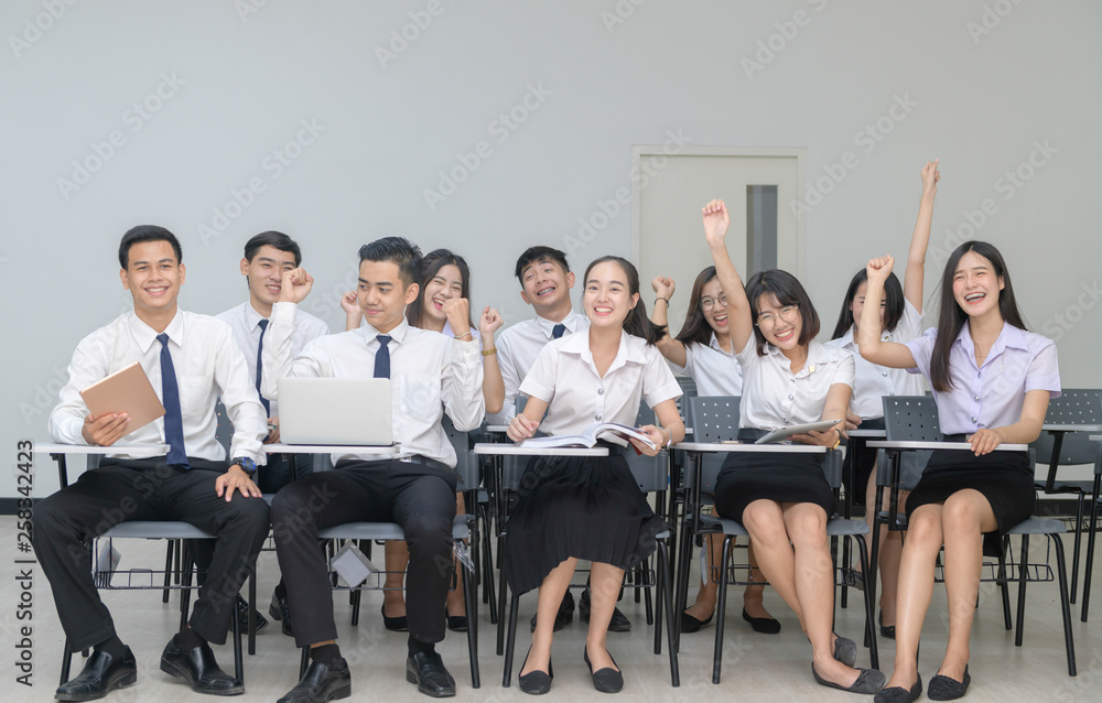 Happy Students in uniform working with laptop Happy Students in uniform working with laptop