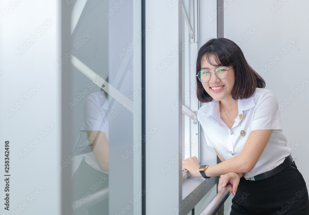 Happy young students in uniform smile near window, Education concept Happy young students in uniform smile near window, Education concept