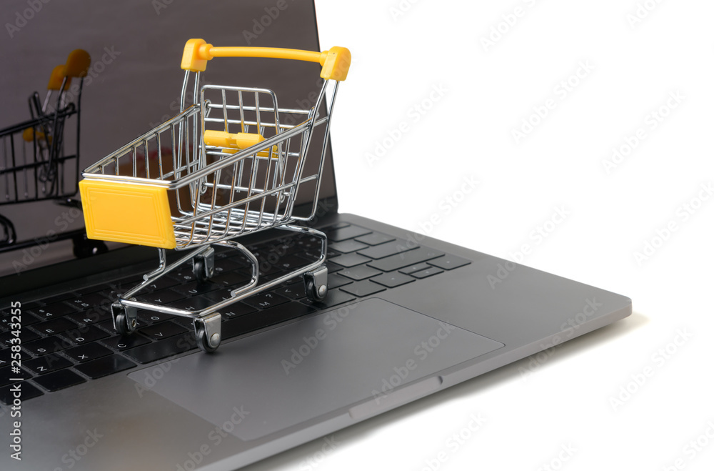 Trolley on a laptop keyboard isolated on white