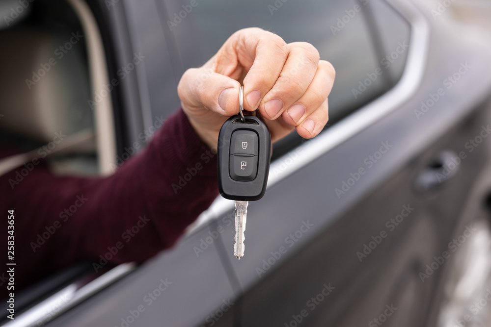 Close up of man holding car keys Close up of man holding car keys