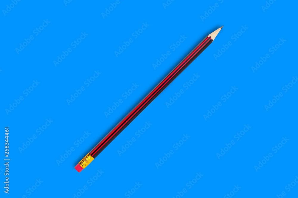 One new wooden graphite pencil with rubber eraser tip in center on blue background